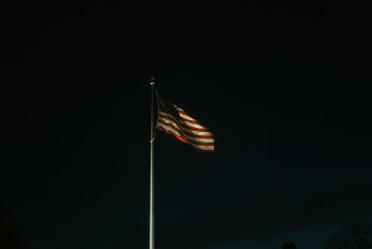 american flagpole lighting at night